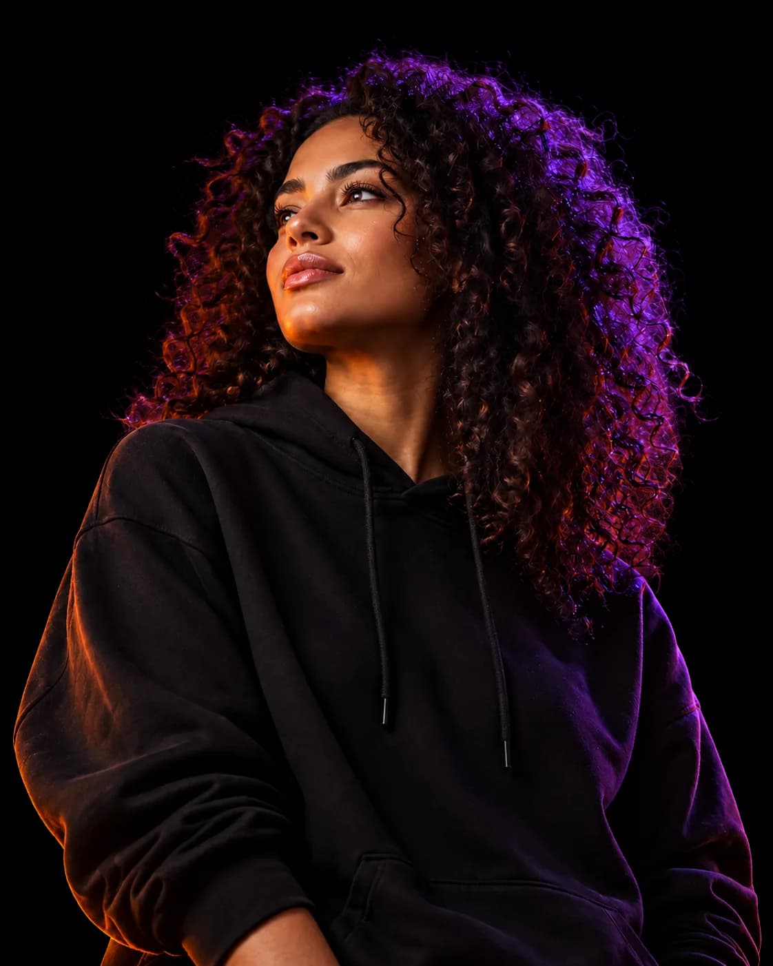 An ambitious entrepreneur in a black hoodie, lit by violet and orange neon